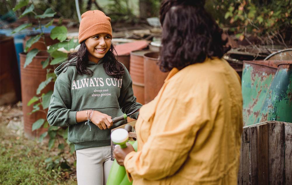 Woman and teenage girl working in a garden